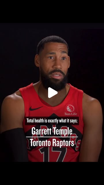 Garrett Temple of the Toronto Raptors speaking to camera in a red Raptors jersey, captioned: Total health is exactly what it says.