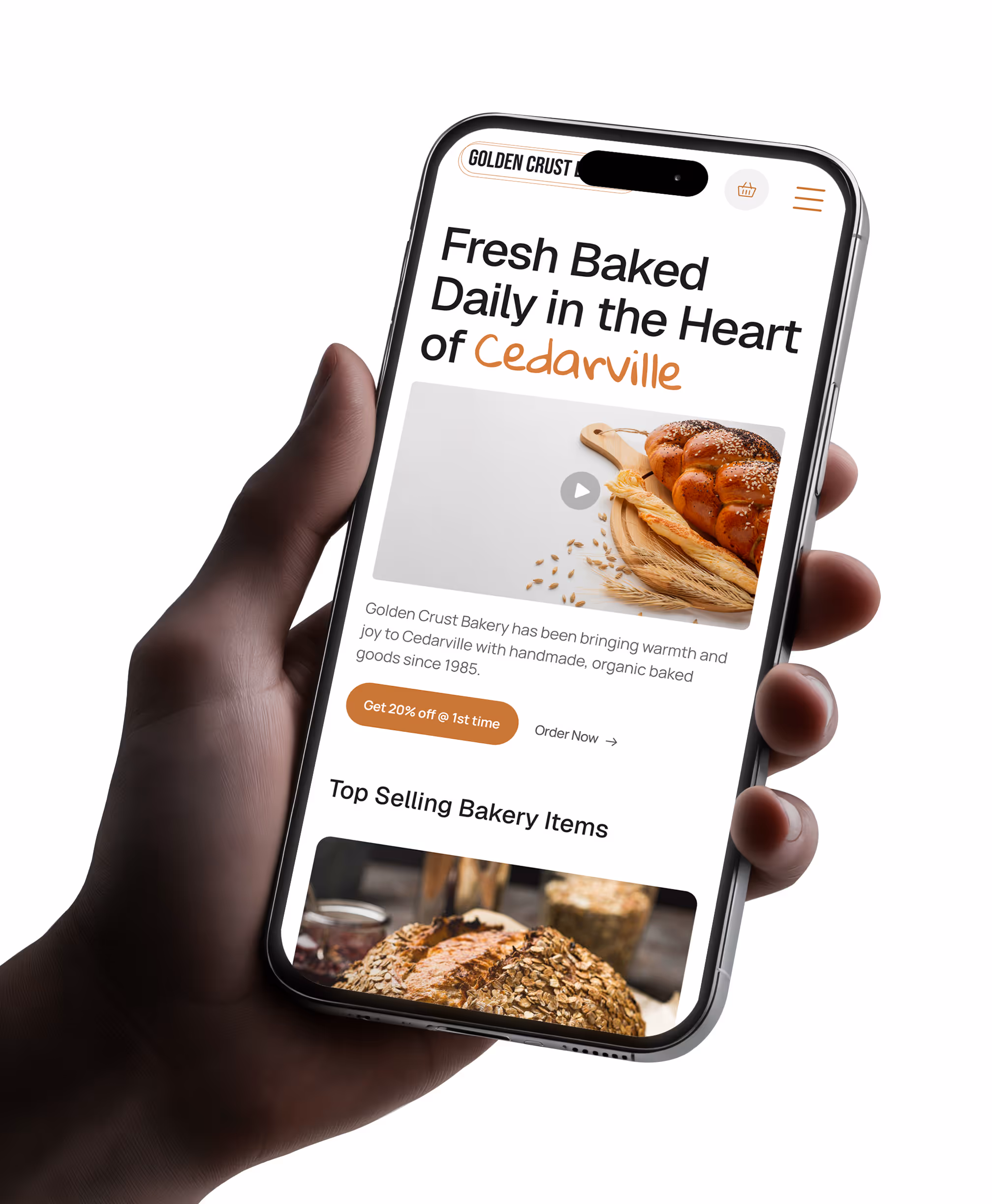 Mobile version of a bakery website shown on a smartphone held in hand, featuring artisan bread and a promotional discount offer for first-time orders.