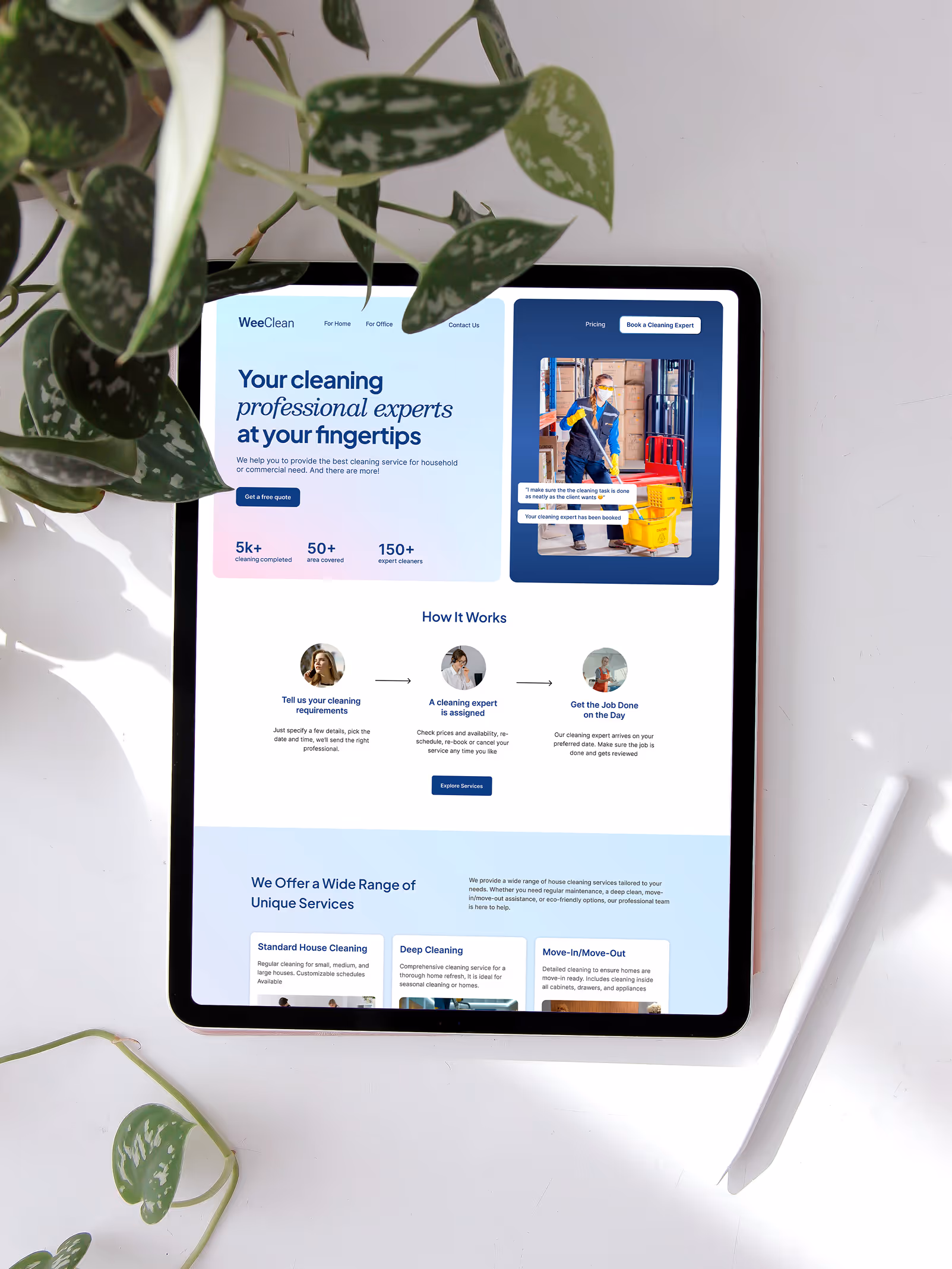 Tablet displaying a professional cleaning service website with booking steps and service offerings, placed on a white surface with surrounding greenery and stylus.