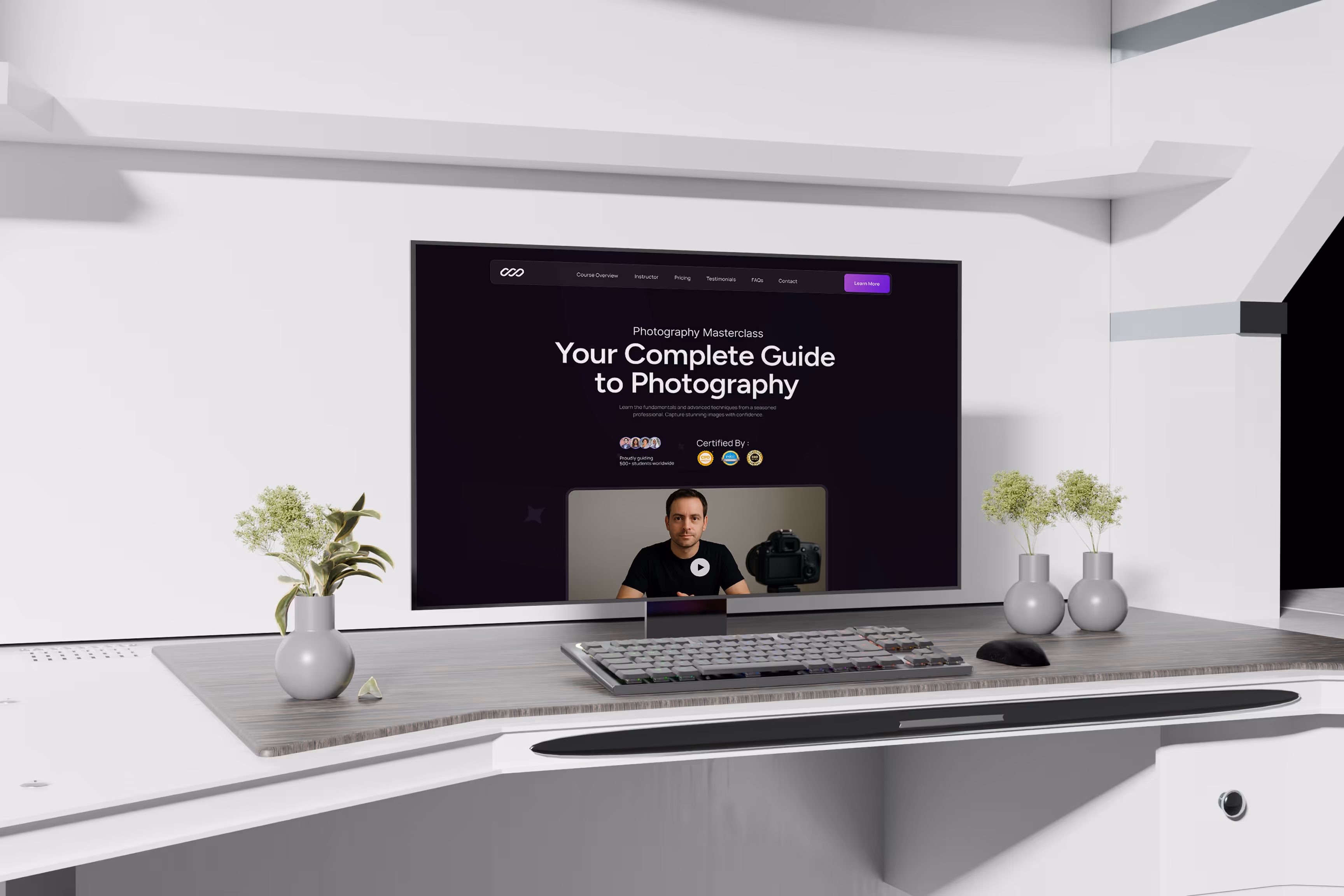 Desktop monitor on a modern white desk displaying a photography masterclass website, featuring an instructor video and course overview, with minimalist decor and small potted plants.