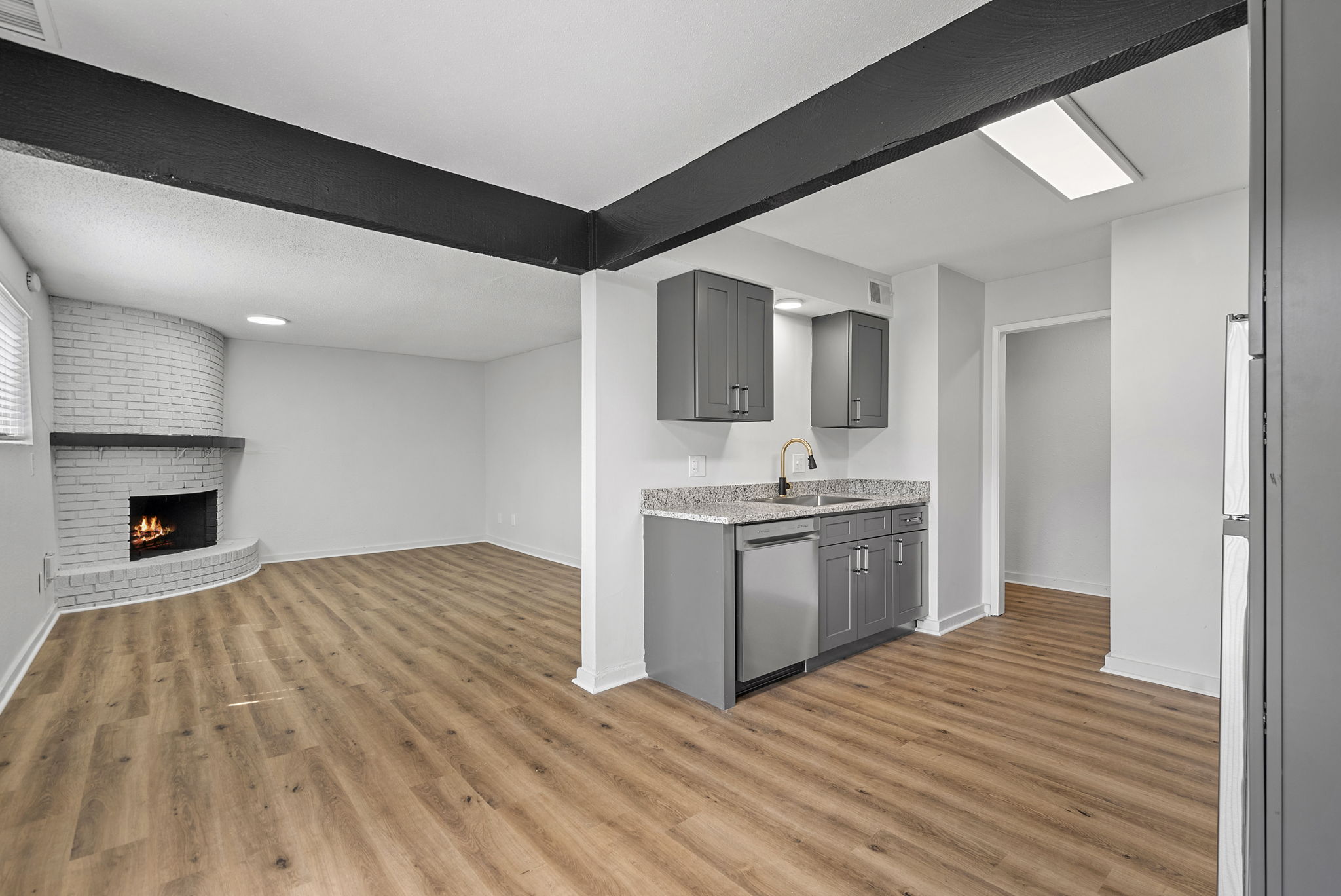 Wide view of dining area and living area with fire place