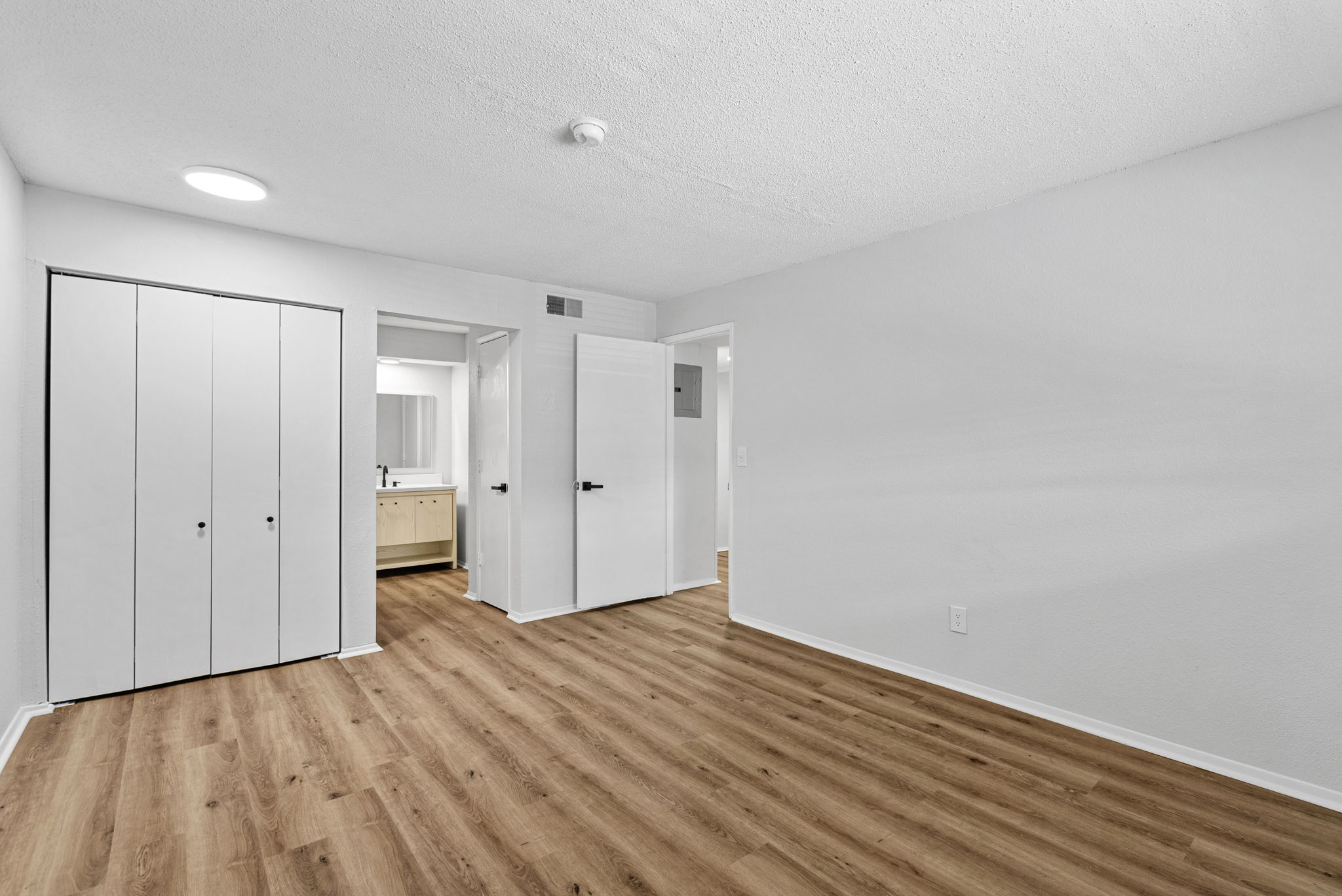 Unfurnished bedroom with wood floors