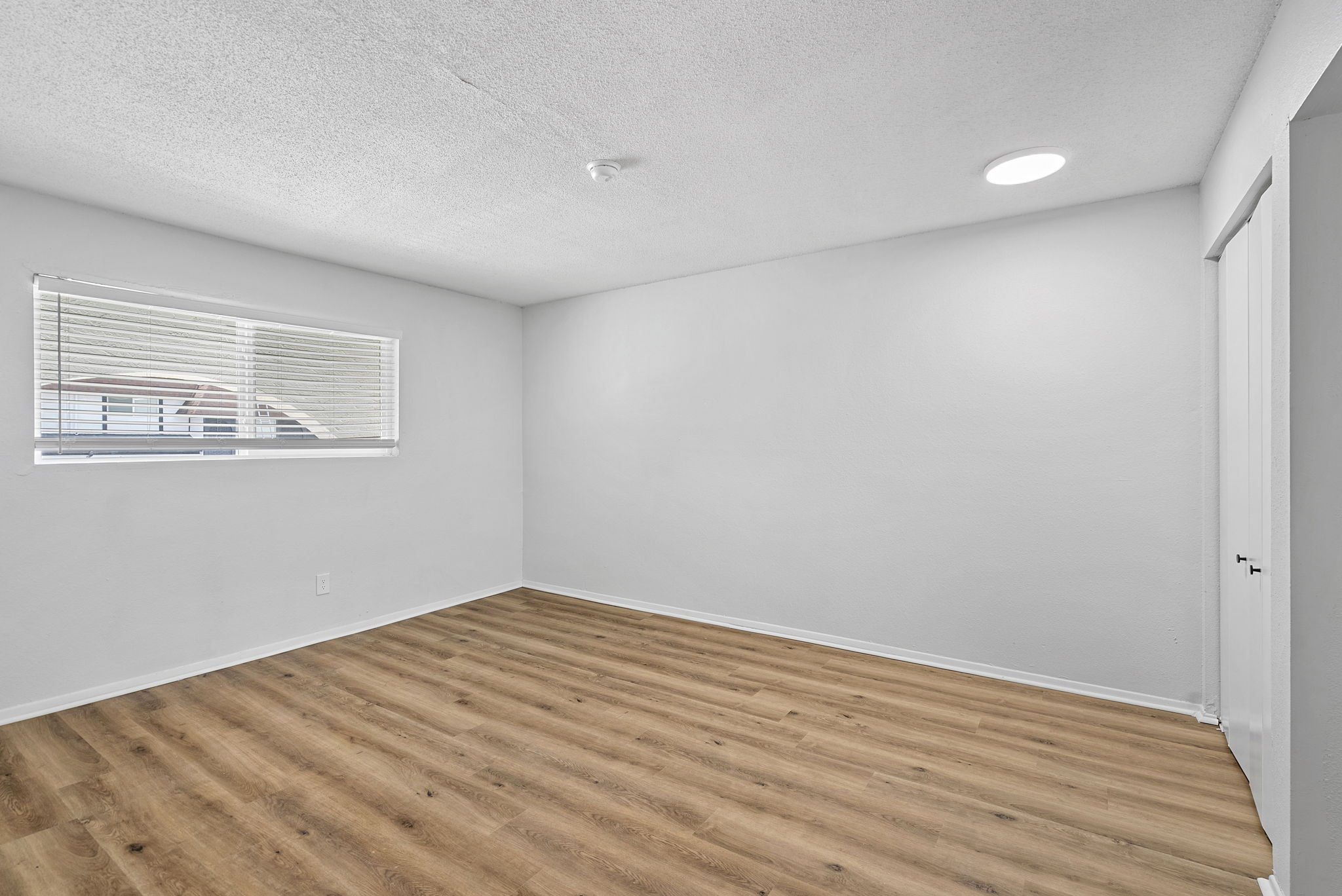 Unfurnished bedroom with wood floors