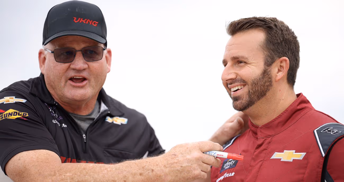 A Viking Motorsports crew member (L) and Matt DiBenedetto (R) share a laugh.