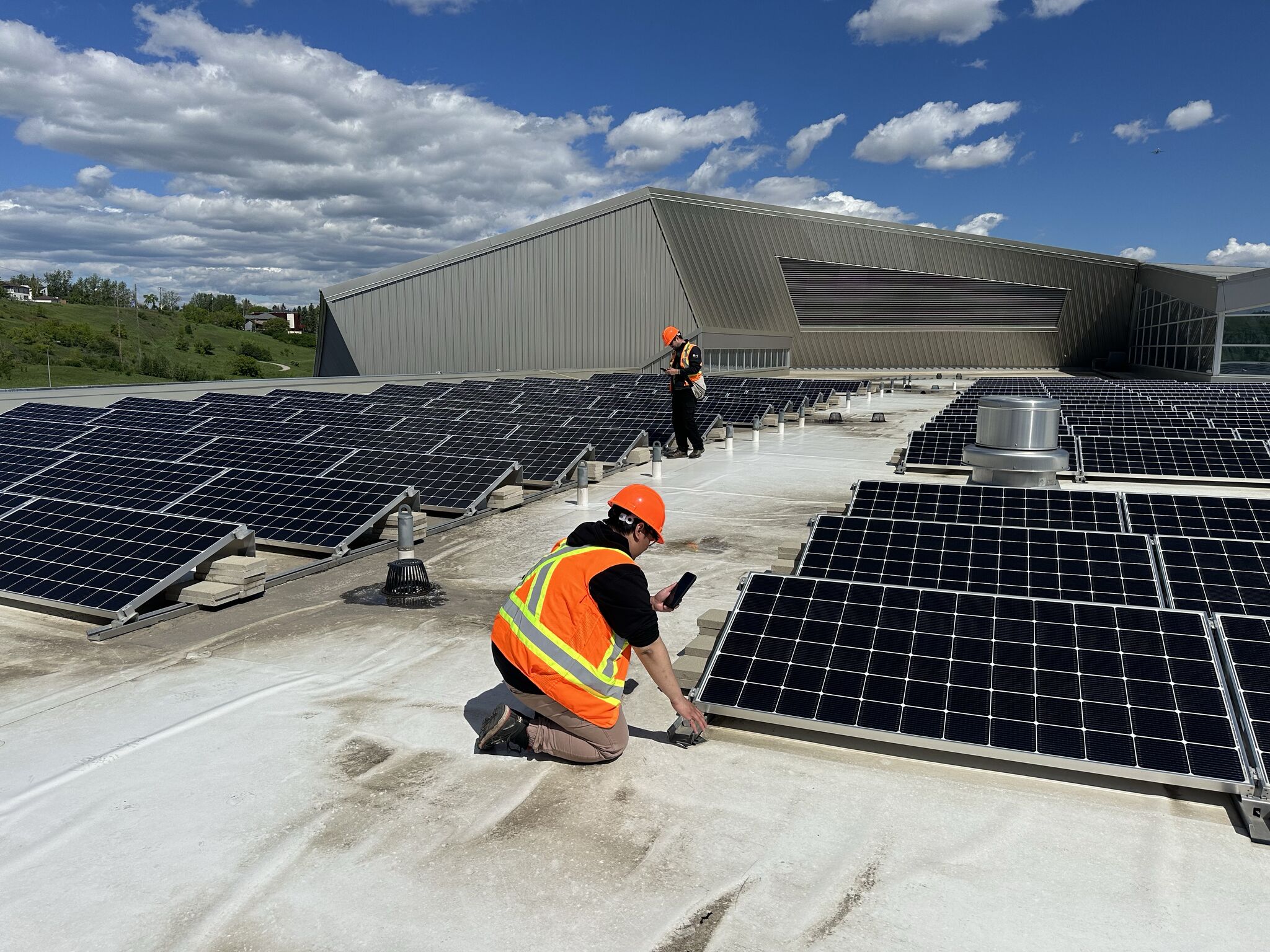 An ASI inspector documenting rooftop equipment during a condition assessment