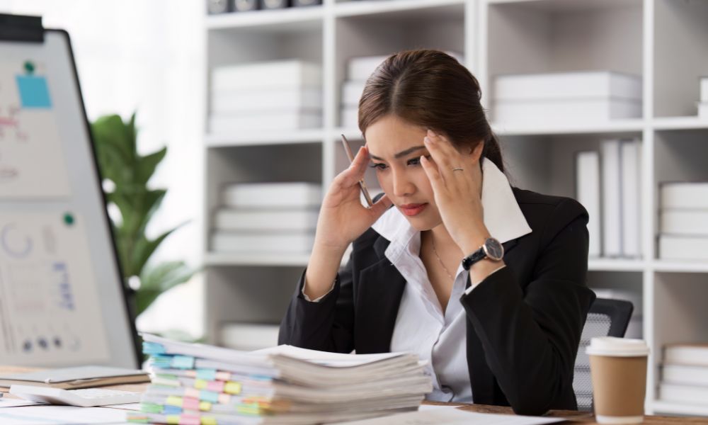 woman frustrated reading spreadsheets and information