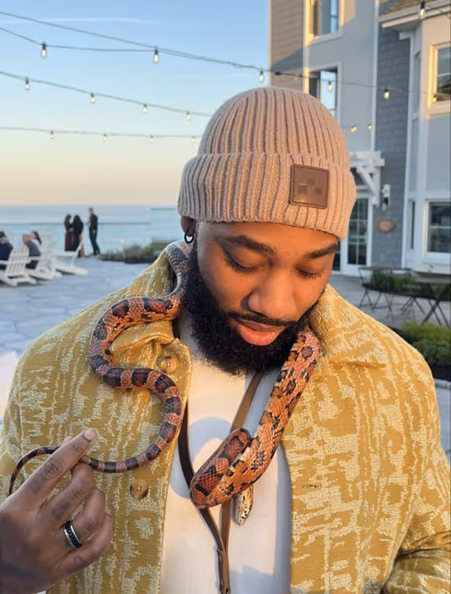 Photo of employee with a snake on his neck