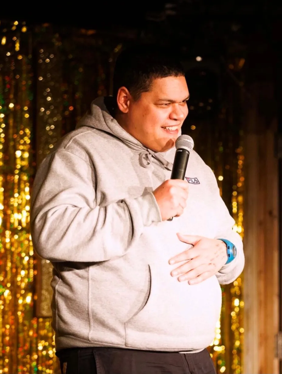 Ed Kear, a comedian, writer, and director from Bristol, smiles confidently, representing the diverse talent and boundary-pushing humour found at a Comedy Freaks comedy show London.