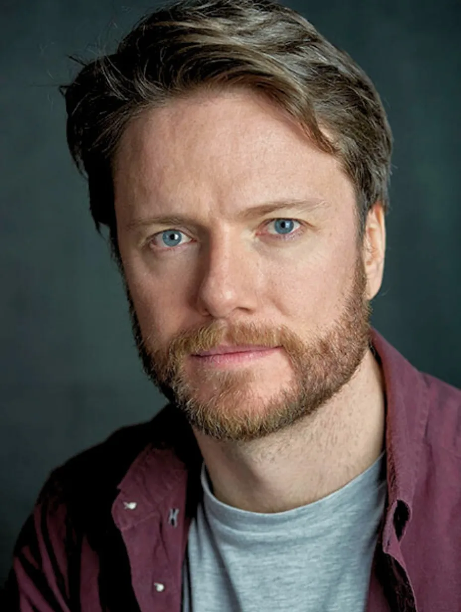 Andrew Nolan, a male comedian from Dublin with a beard and blue eyes, looks directly at the camera with a confident expression, showcasing his professional demeanour for a Comedy Freaks comedy show London.
