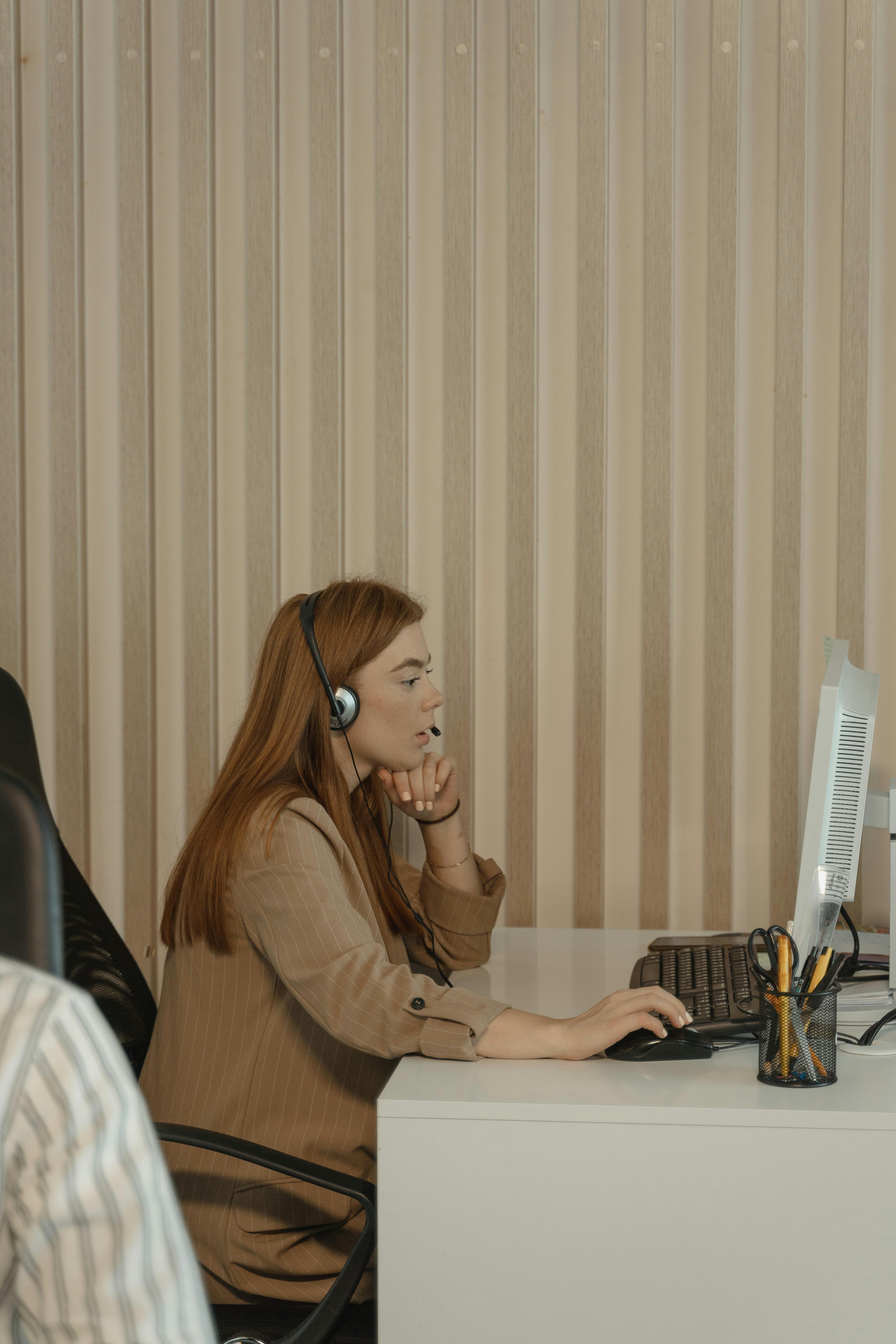 Girl sitting at her work space from the side