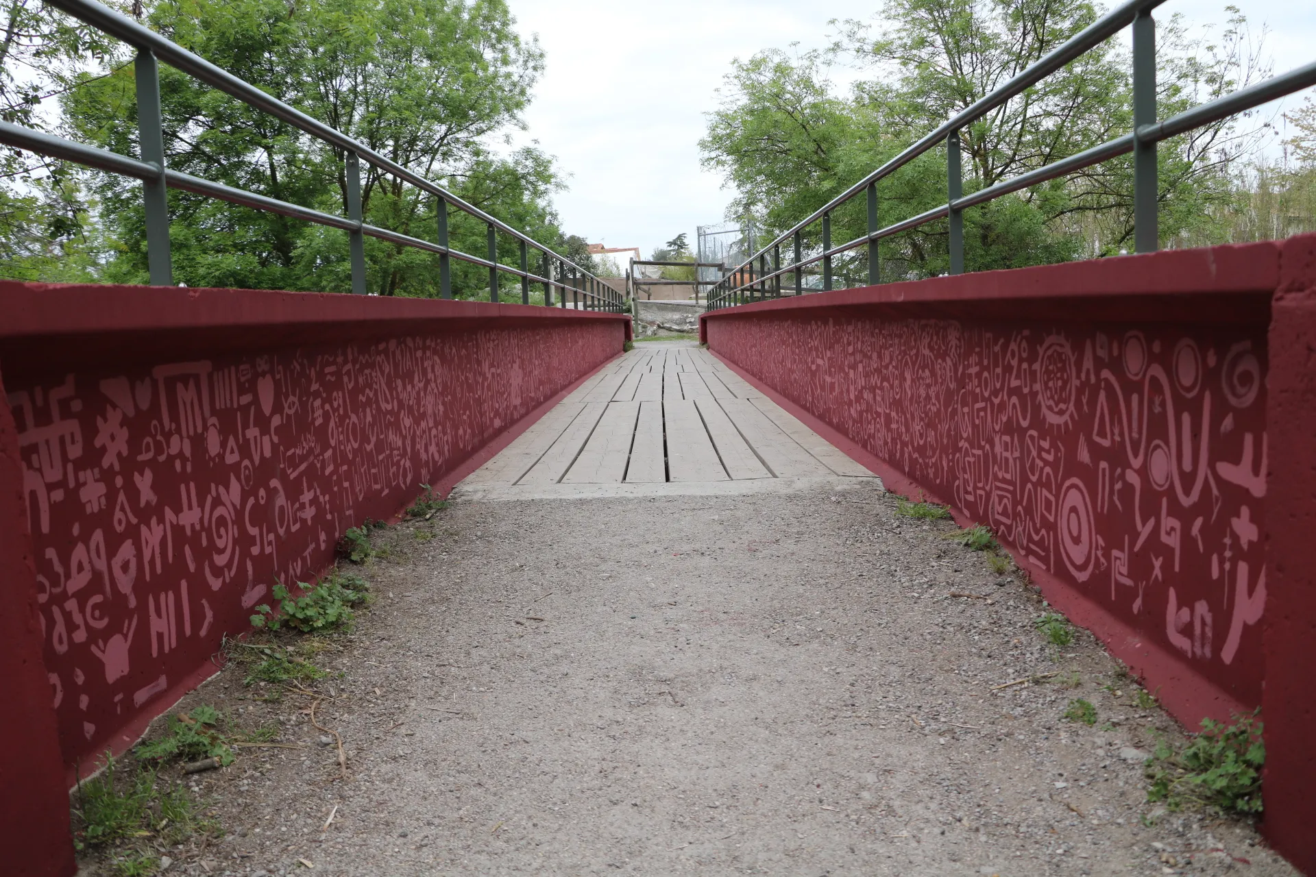 Vue centrale de la passerelle rouge décorée, prise en enfilade depuis le sol