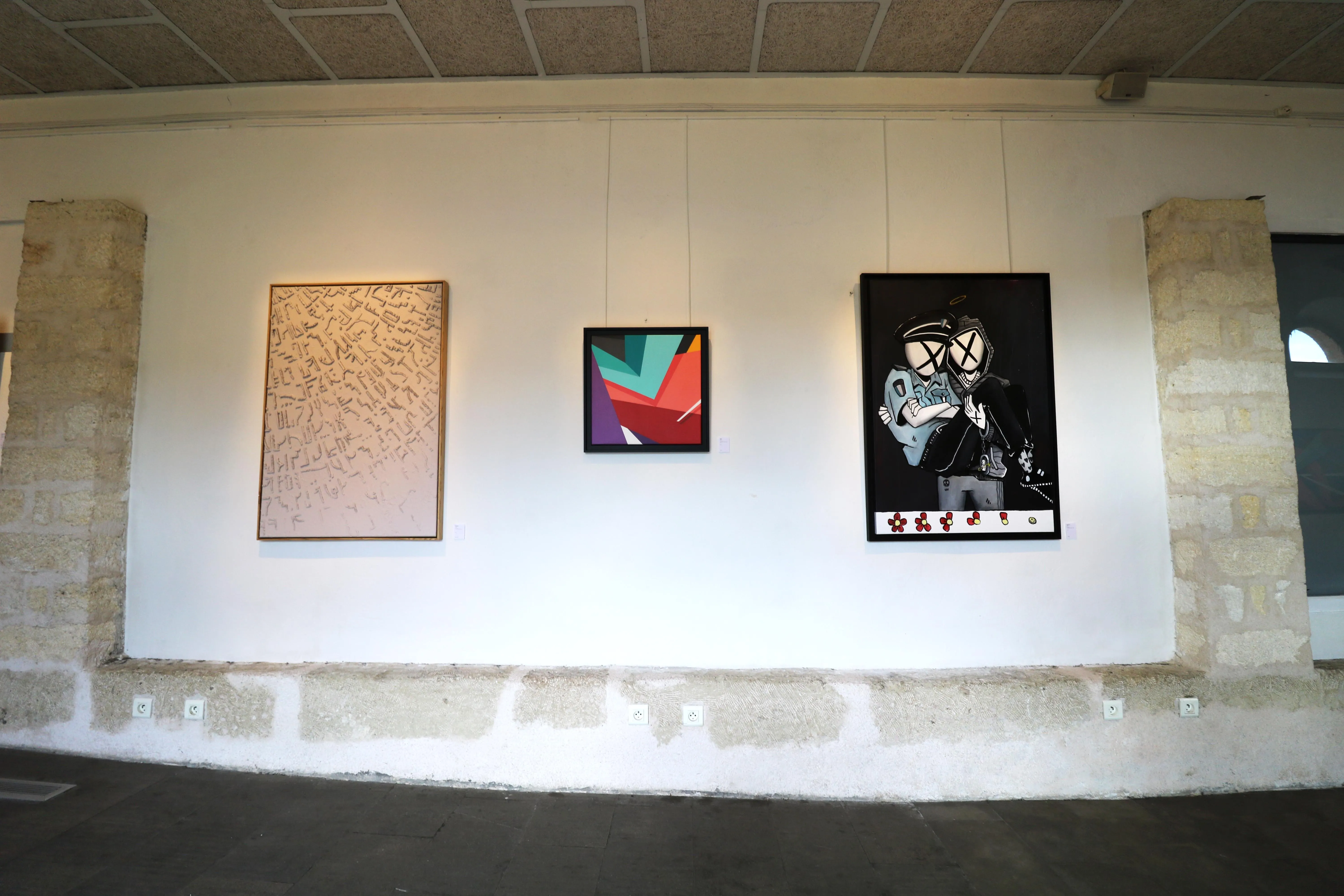 Mur de galerie présentant plusieurs œuvres contemporaines aux styles variés