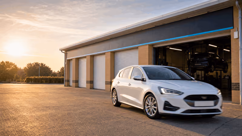 The HiQ workshop at Towcester with a car parked outside