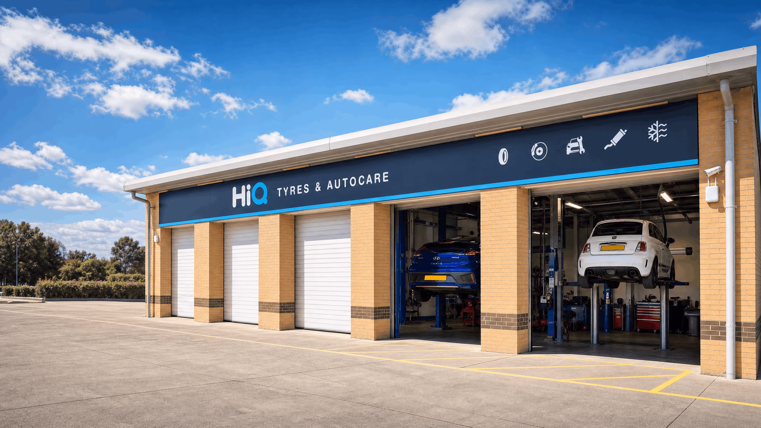 HiQ Tyres & Autocare service centre with cars in the workshop bays