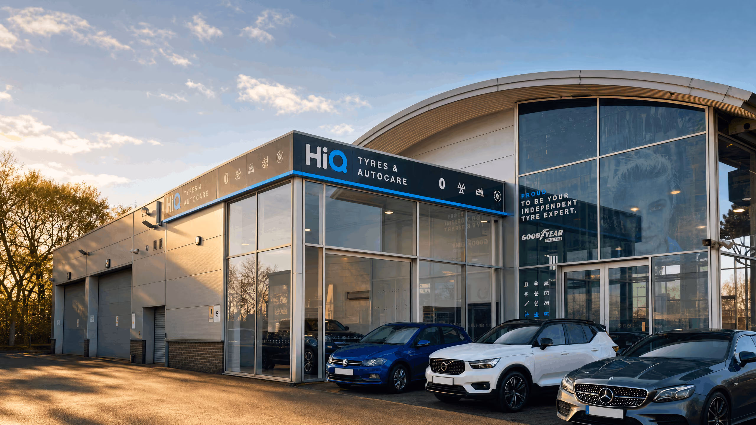 HiQ Tyres & Autocare frontage in Bolton, with cars parked outside