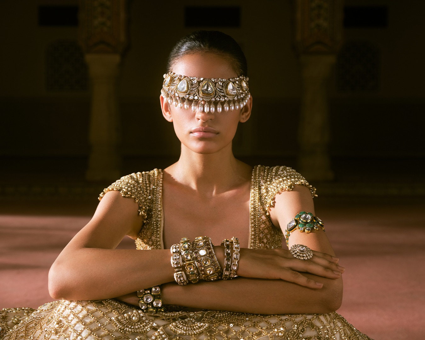 Model wearing The Grand Hall from The Jaipur Edit by Raniwala 1881, a Polki and pearl choker worn as headgear with Polki kadas, a bajuband and a ring