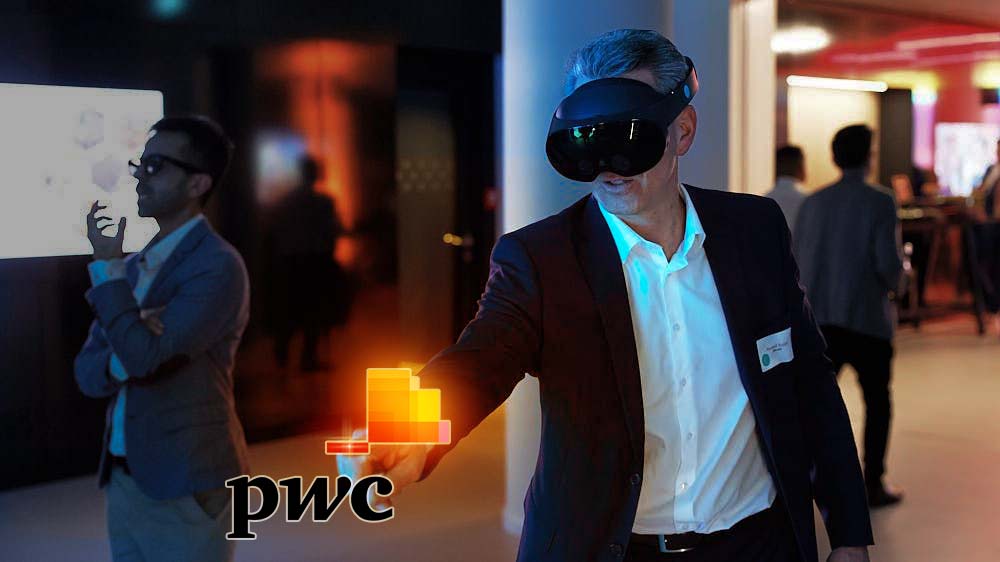 Man in business attire using a VR headset with glowing digital graphics and PwC logo in a modern indoor setting.