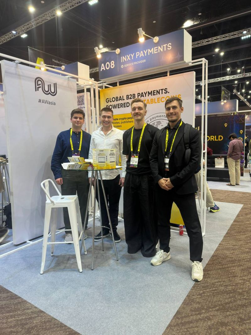 INXY Payments team at their stand at Affiliate World Asia