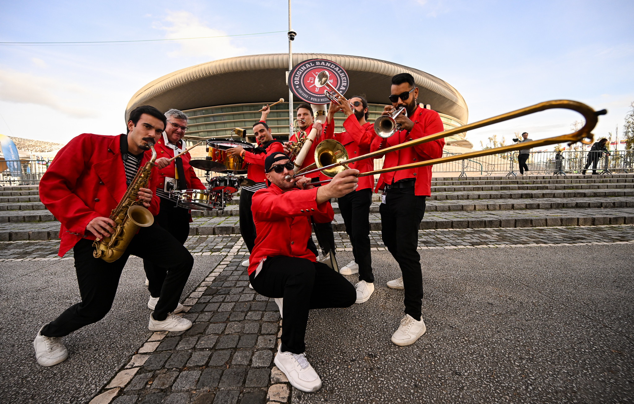 Performers in red uniforms outside the Web Summit Lisbon venue