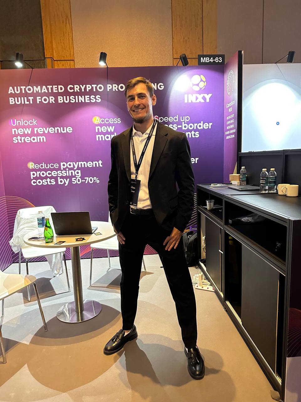 INXY Payments team member at the stand at TOKEN2049 Asia
