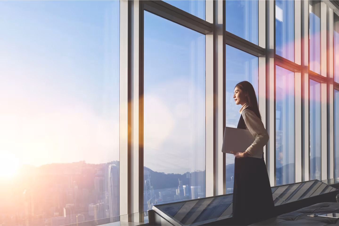 Fashionably dressed business woman smiling and looking into the distance