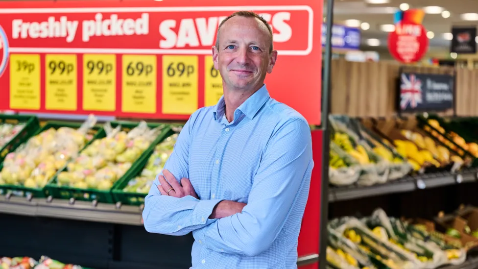Aldi boss says, "shoppers are treating themselves ... as cost of living pressures start to ease"