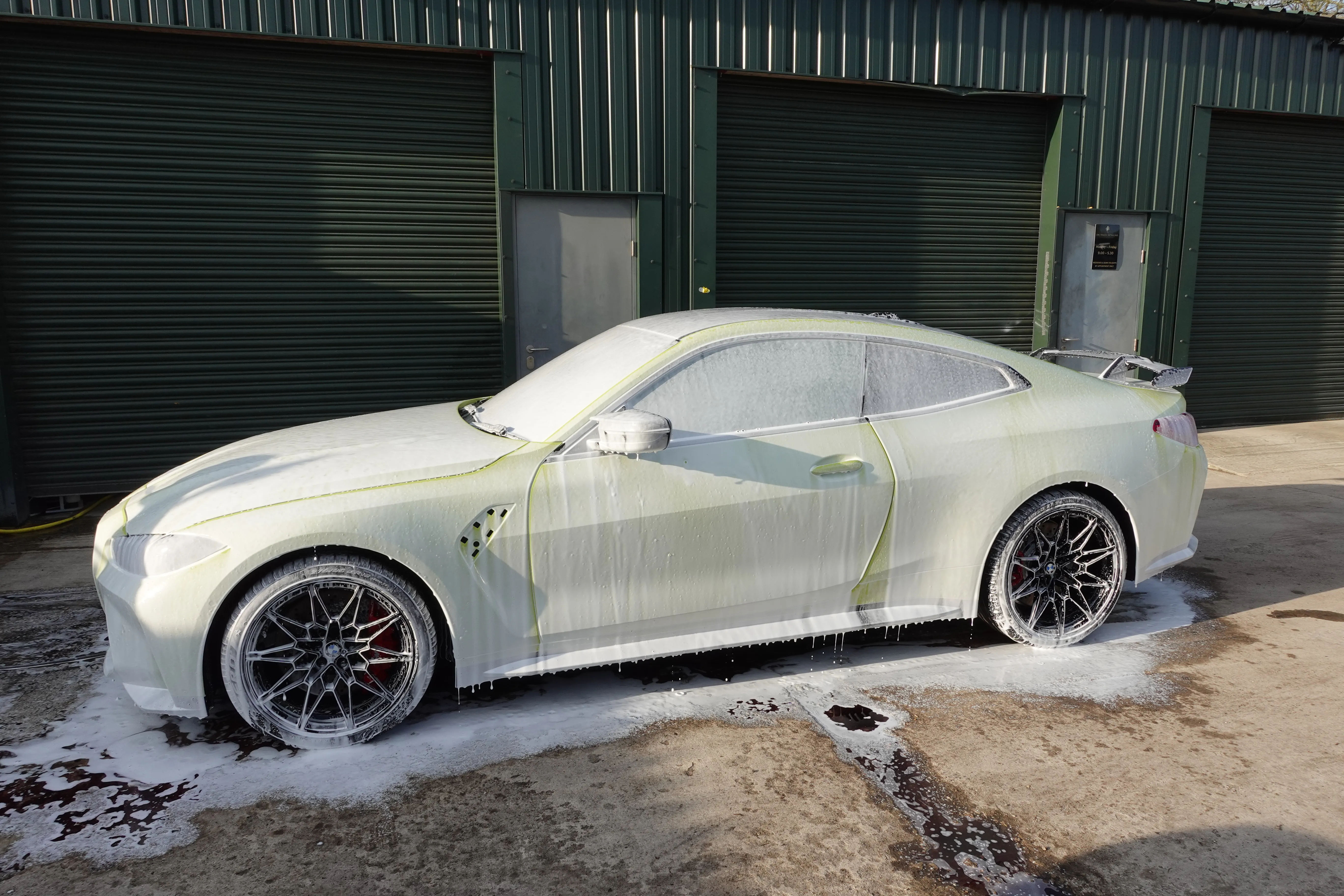 A BMW M4 Undergoing a maintenance wash, safe for ceramic coatings and paint protection film