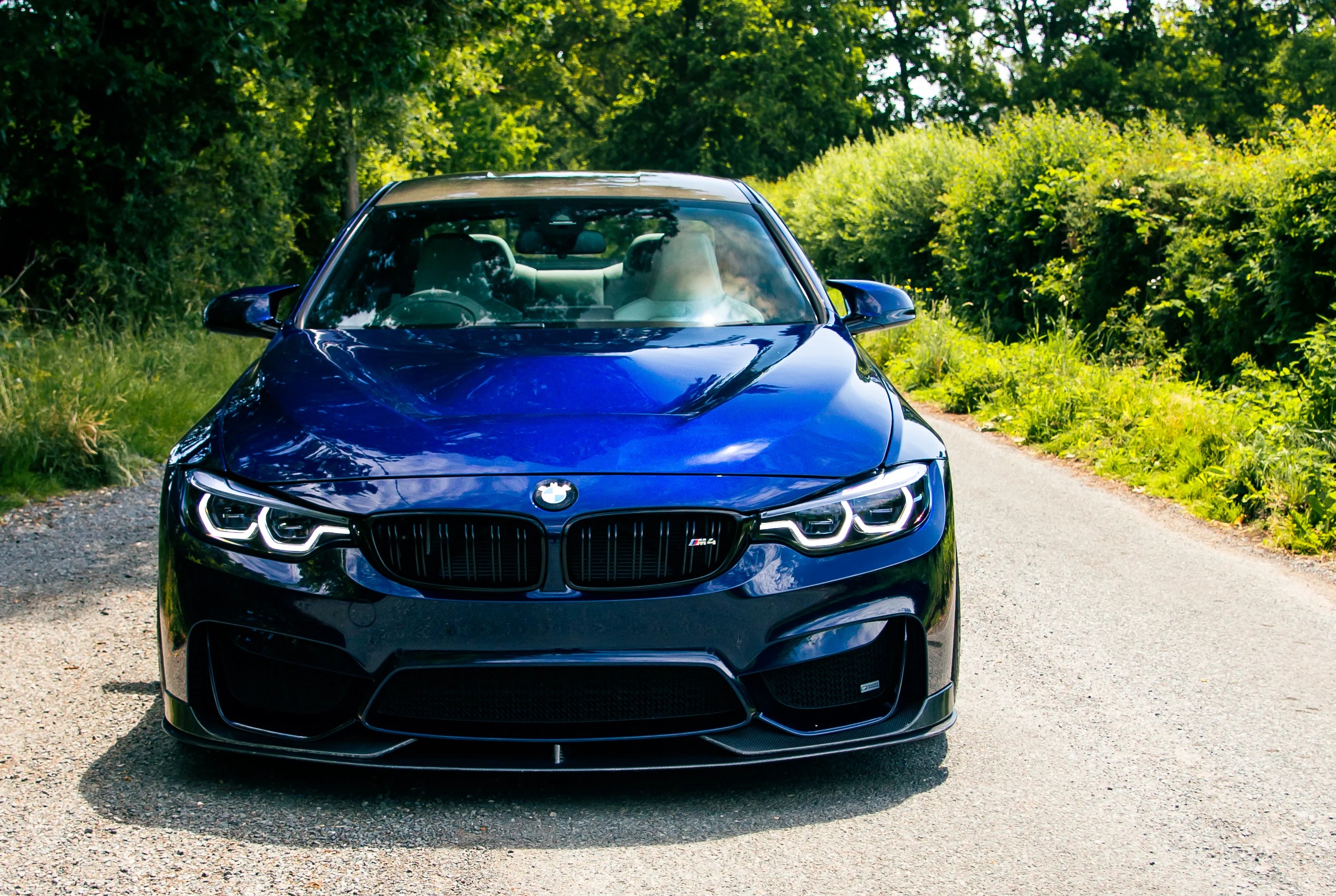 BMW F82 M4 with a light smoke tinted PPF on the headlights, 50% VLT, road legal, protection from stone chips, fitted at On Track Detailing Berkshire, near Reading and Wokingham