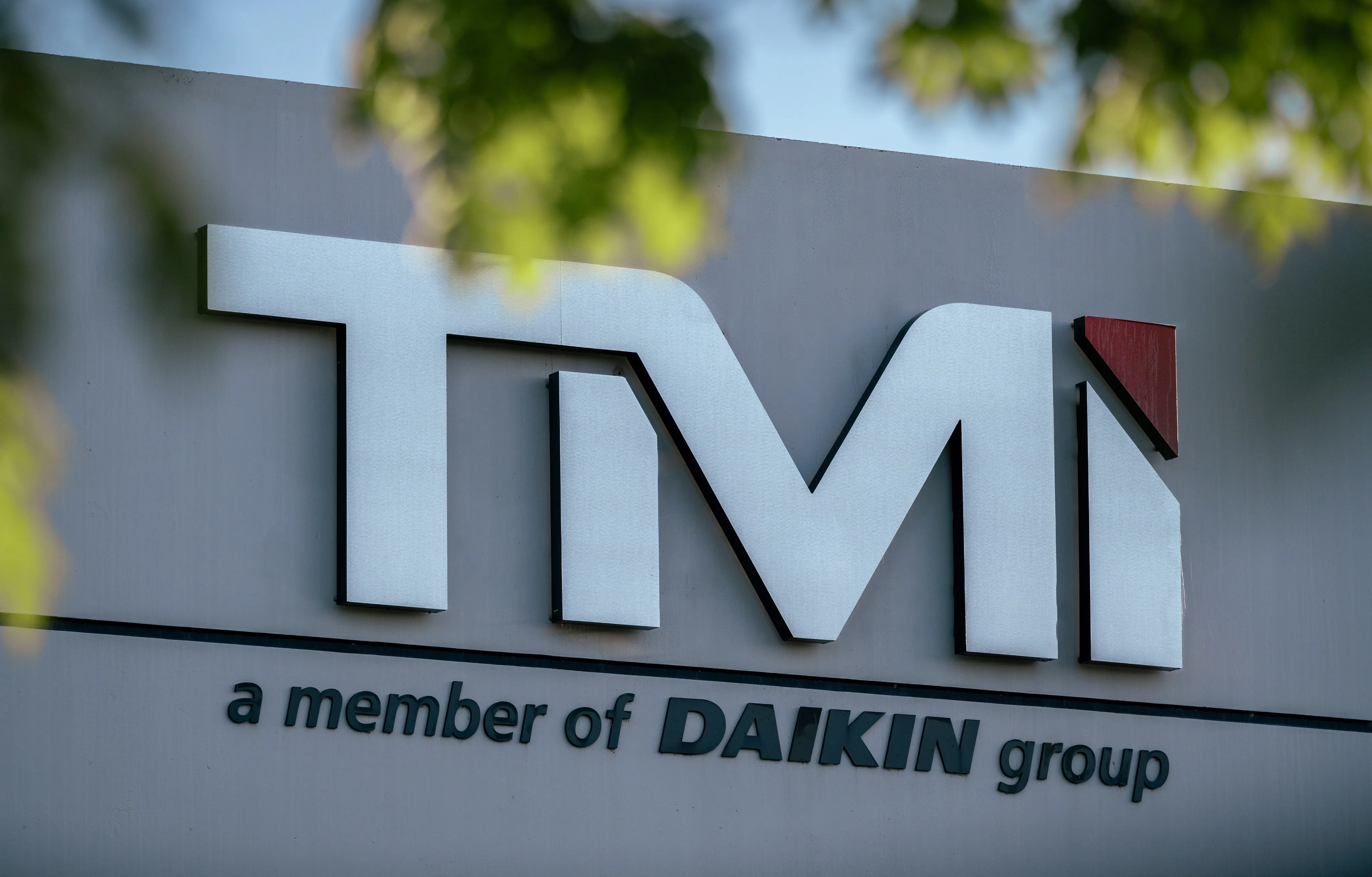 tmi brand logo on a wall