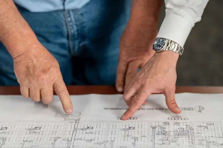pointing at design on paper