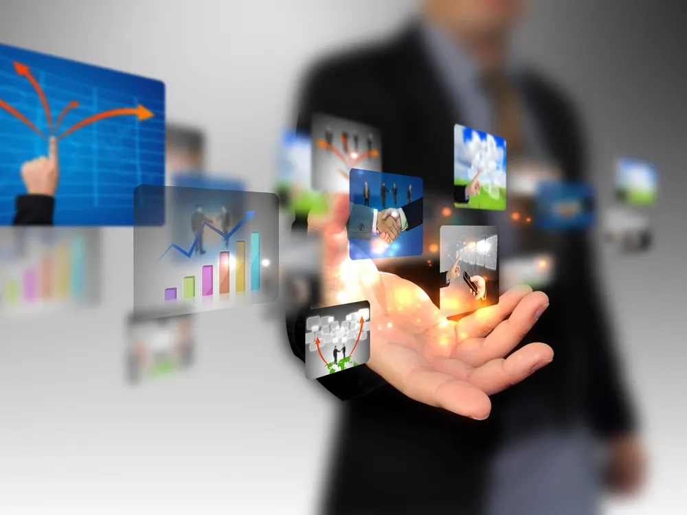 Business professional interacting with floating digital screens showing graphs and connections