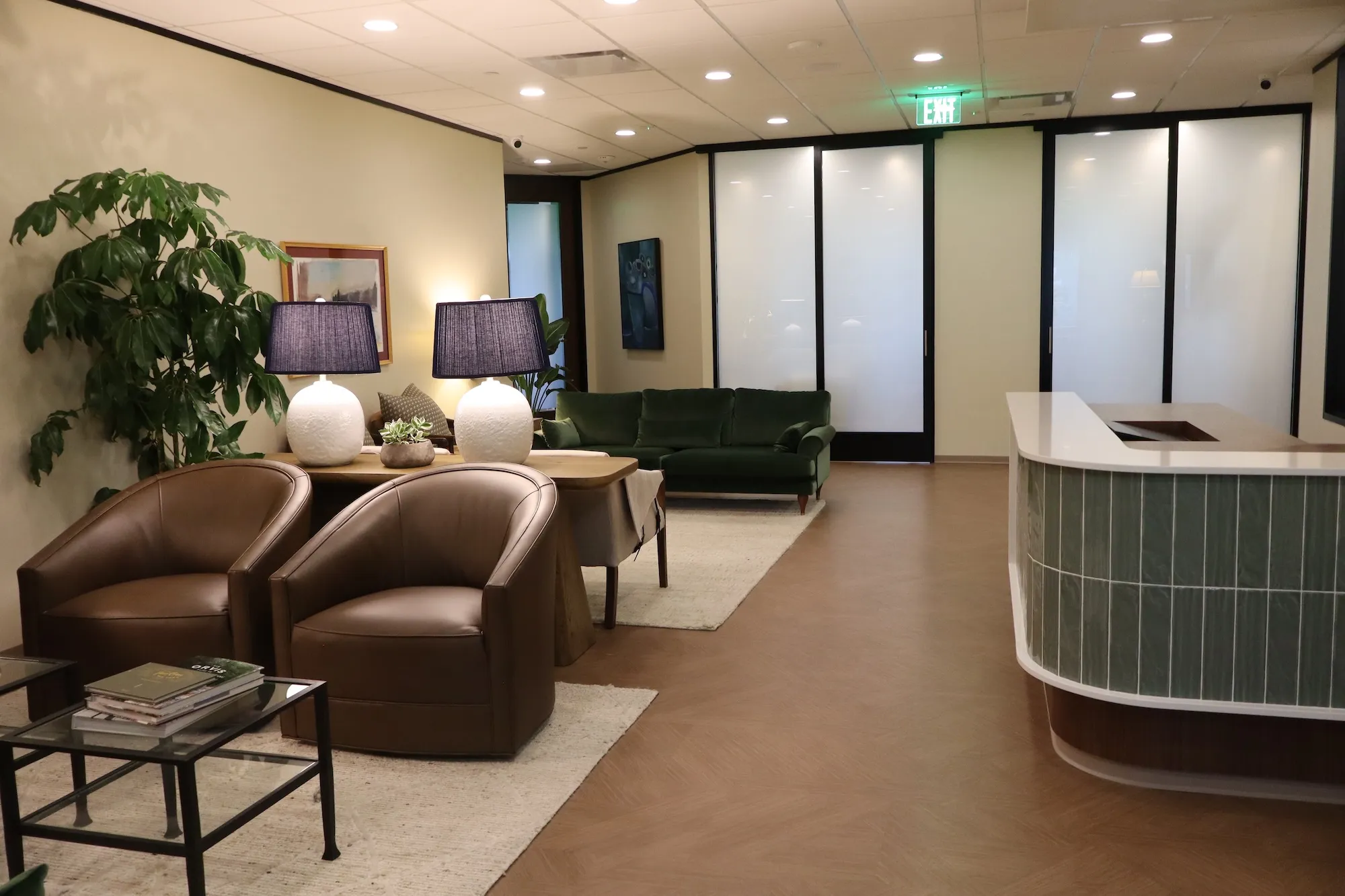 Reception area at Tanglewood Dental Associates with leather armchairs and a curved front desk