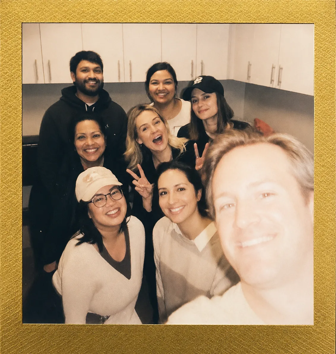 Polaroid-style group selfie of the Tanglewood Dental Associates team in white scrubs