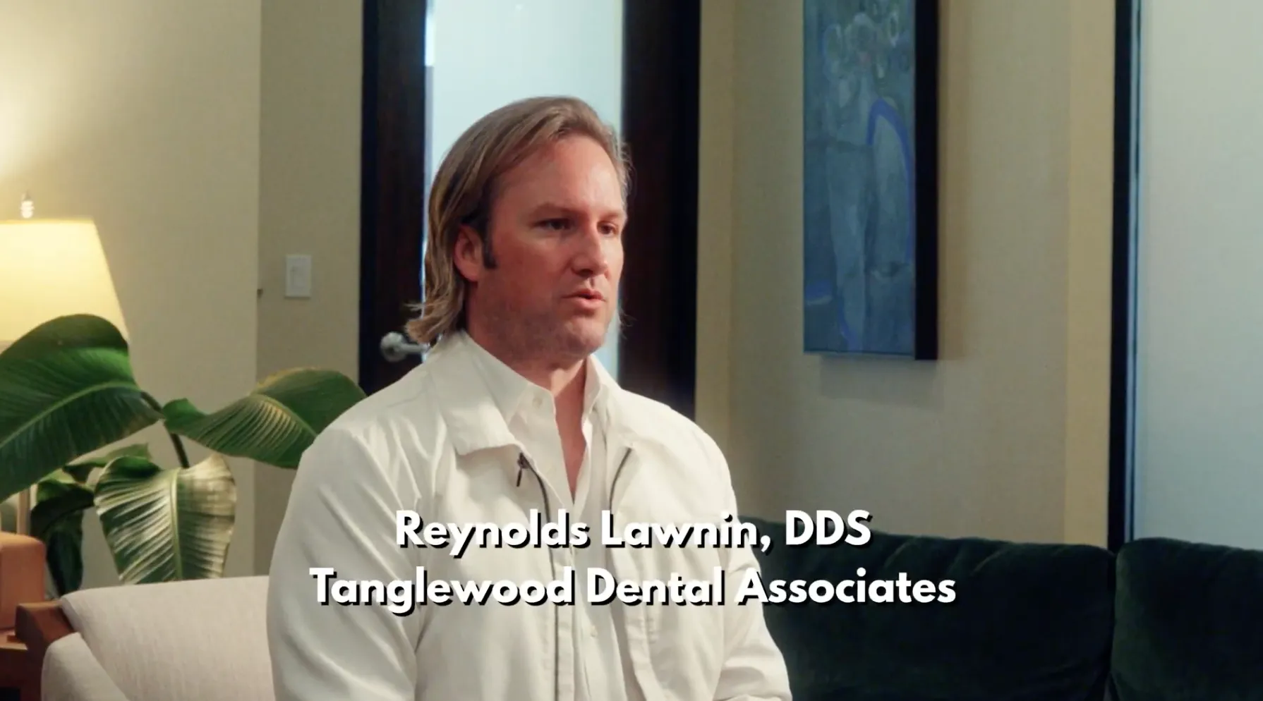 Dr. Reynolds Lawnin, DDS, seated in a white coat during a video interview at Tanglewood Dental Associates