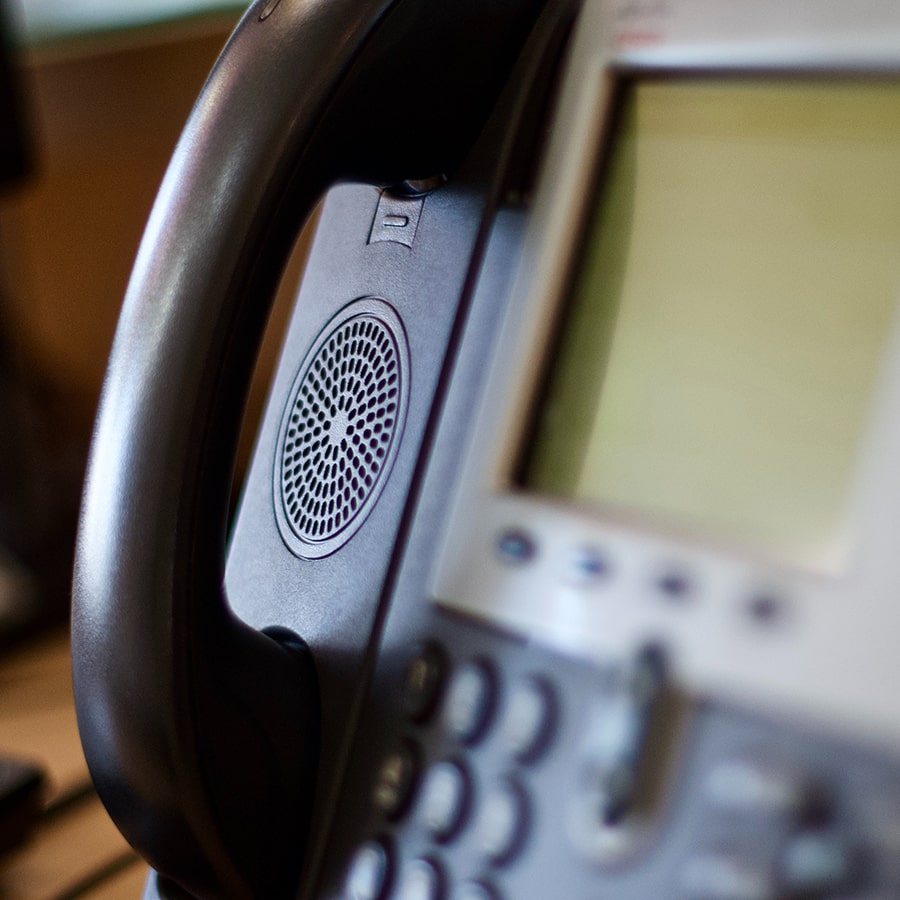 Close-up of a VoIP hotel phone system with modern handset and integrated speaker