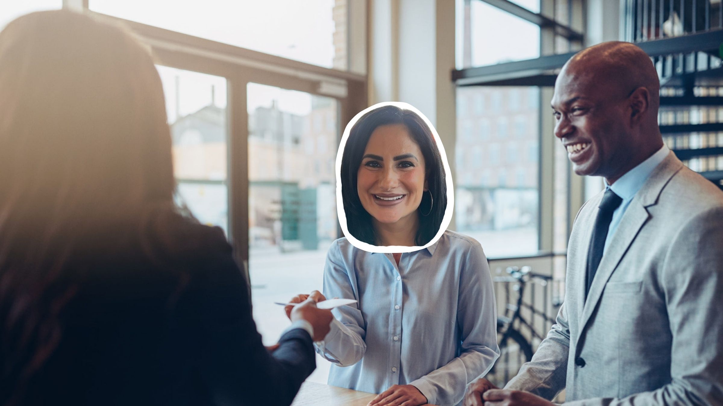 Amanda from Think Simplicity smiling while meeting with new clients in a modern office setting.