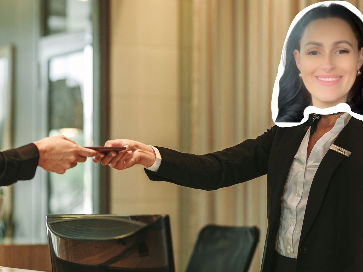 Hotel front desk staff member with a swapped face humorously edited, handing over a key card in a hospitality setting—part of Think Simplicity’s team personality series.