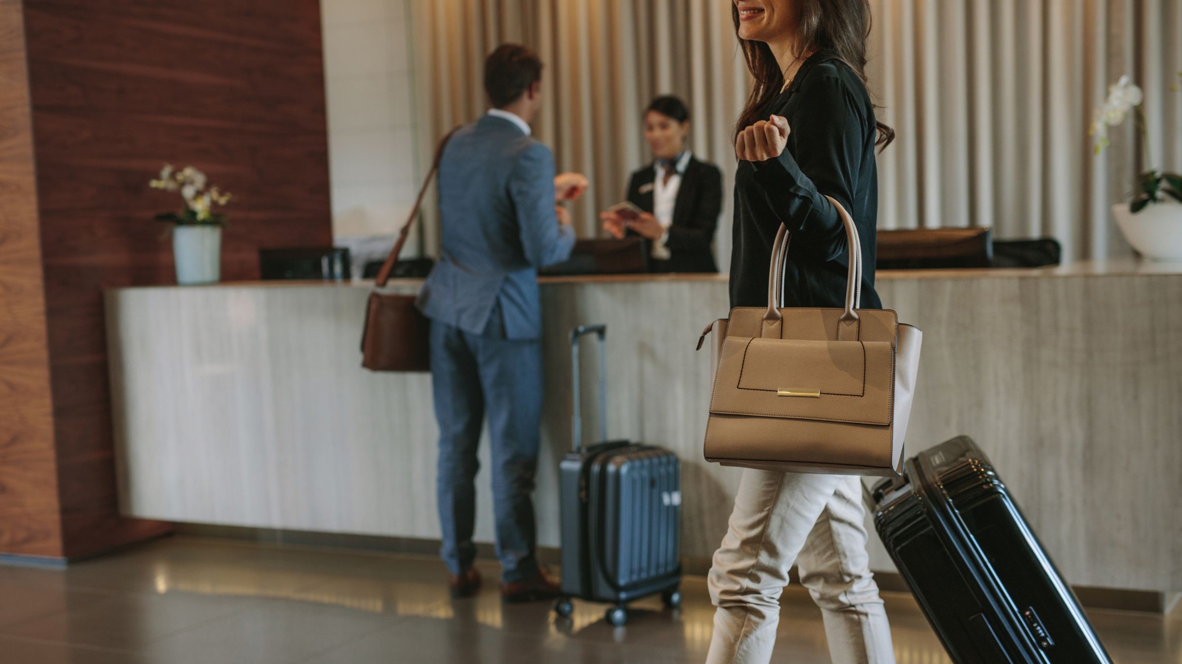 Woman looking at her phone while sitting in a hotel lobby