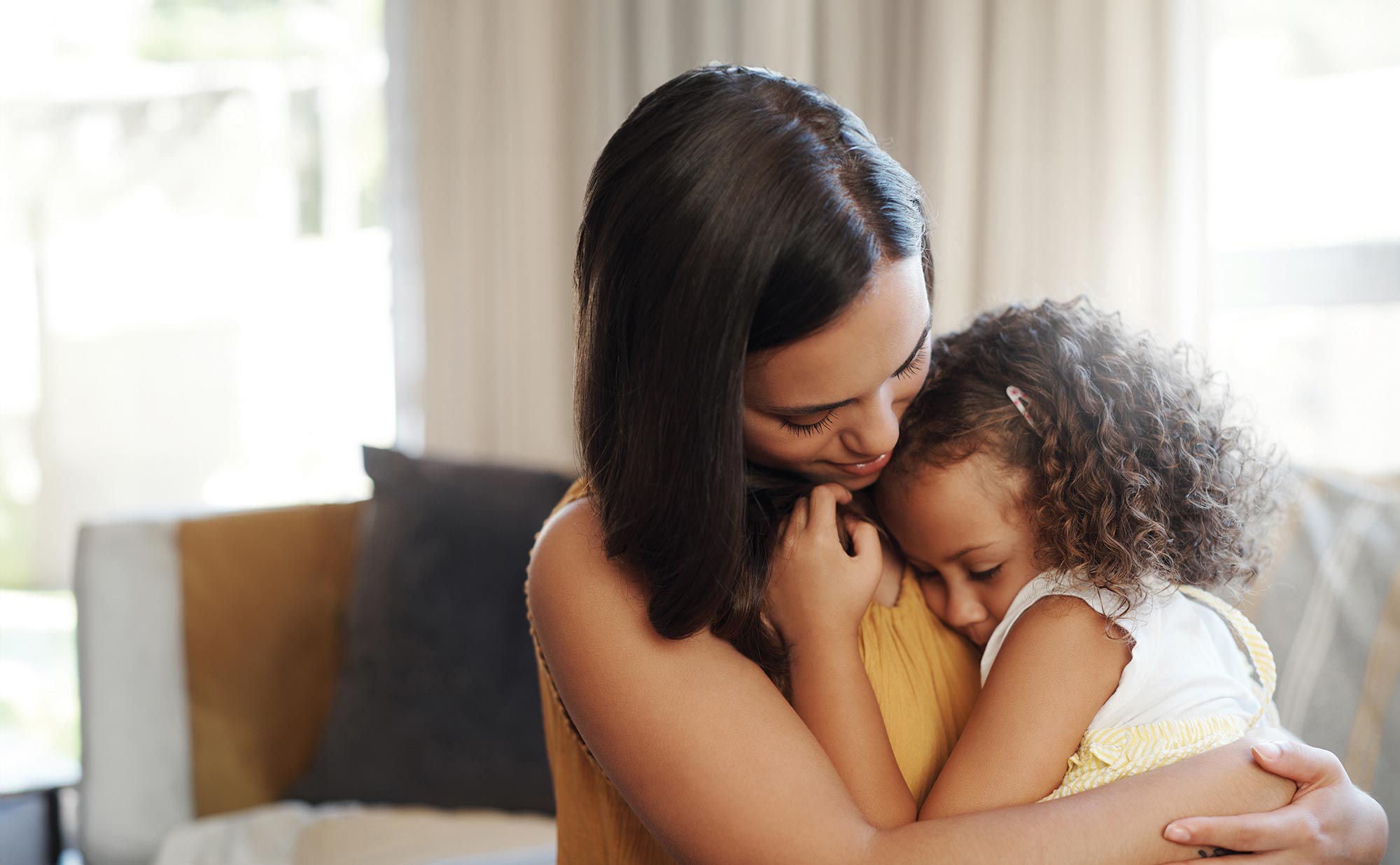 Photo of a young mother holding her small child