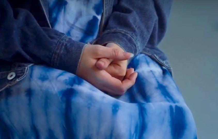 Photo of a survivor's hands in her lap