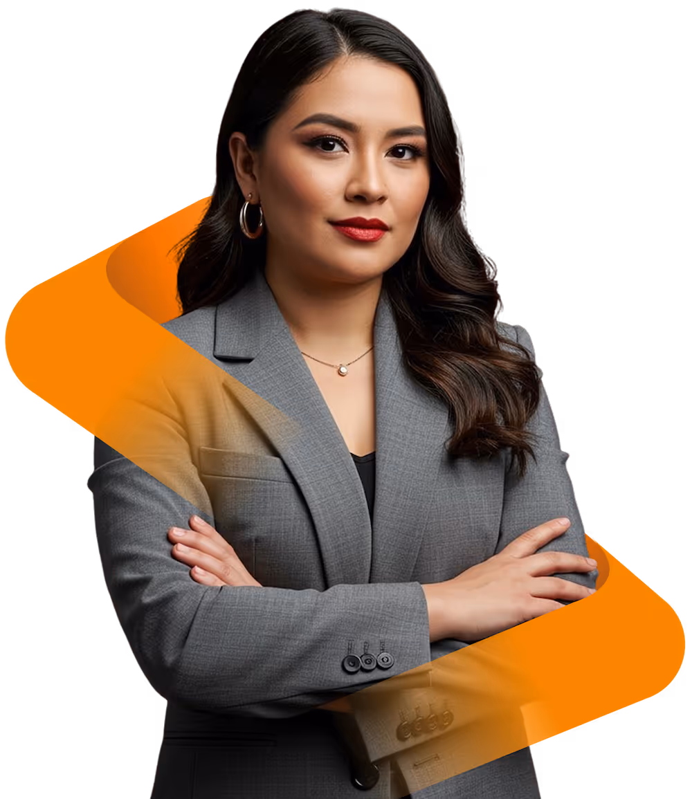 Confident woman with long dark hair wearing a gray blazer and red lipstick, arms crossed.