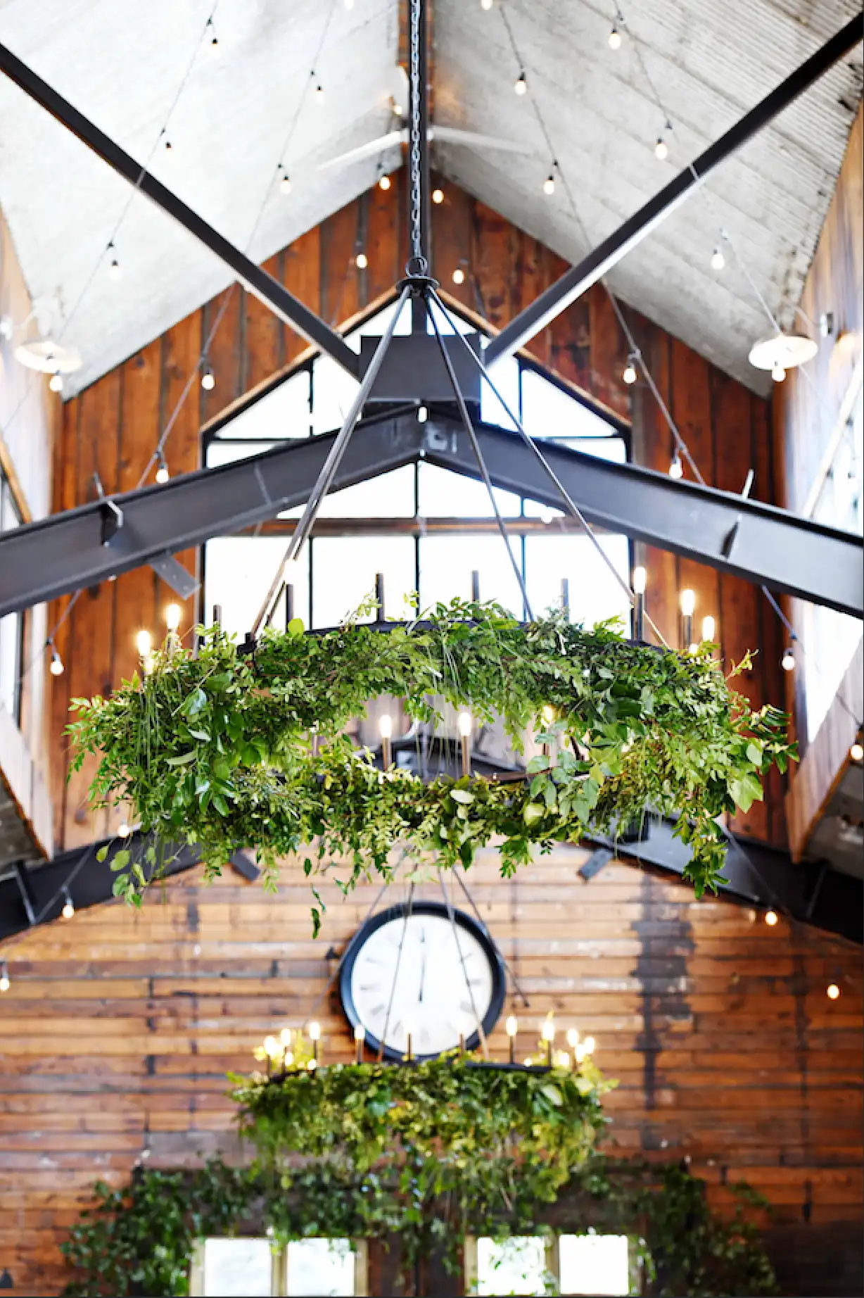 Chandelier adorned with fresh greenery wreath
