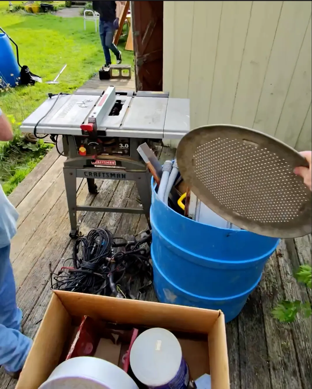 A barrel that is being used to store small metal pieces for scrap metal