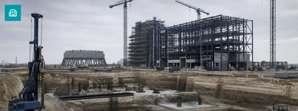 Power plant under construction with foundations and cranes