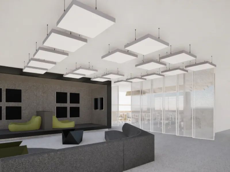 Modern office lounge with gray sectional sofa, green chairs, geometric table, and ceiling light panels.