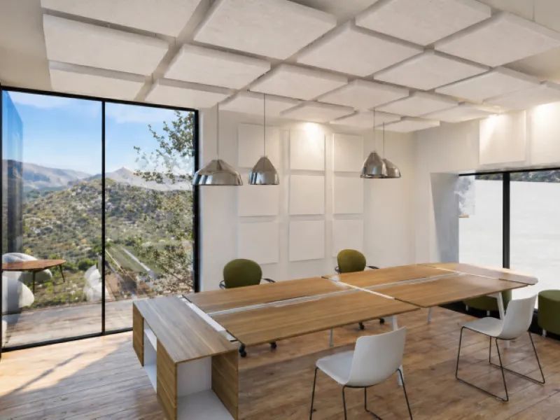 Modern office with wooden tables, white and green chairs, large windows showing mountain view.