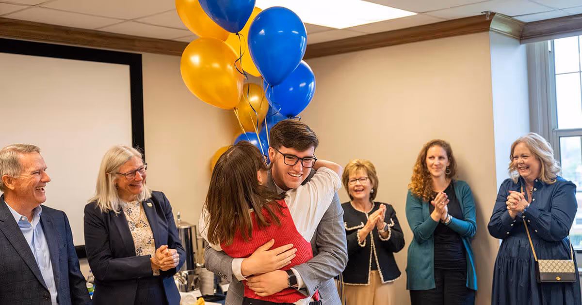 Leah Loveday hugging former Truman Scholarship winner Trent White