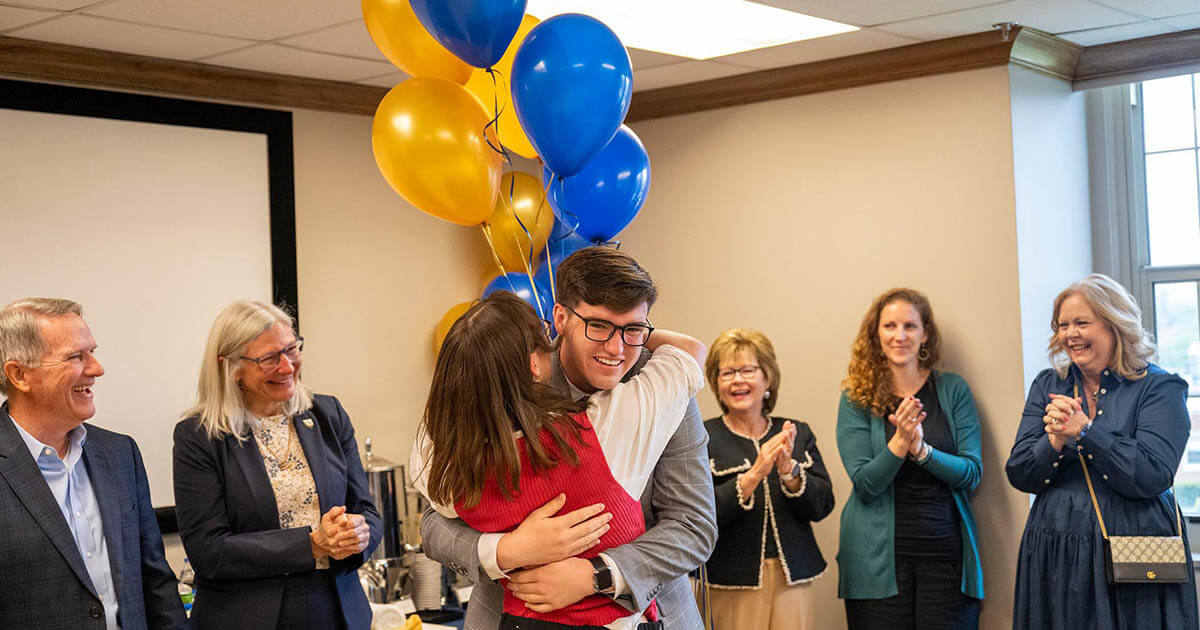 Leah Loveday hugging former Truman Scholarship winner Trent White
