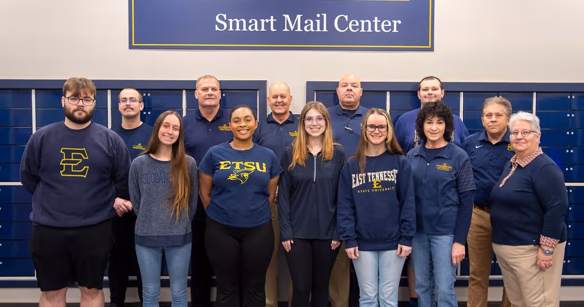 This group photo of ETSU Postal, Passport and Printing Services staff includes, from left-right, front row: Caleb Smith, Alexis Thacker, Irianna Blair, Amelia Arden, Cheyenne McCullough, Teresa Yercheck and Lisa Fields; and back row: Tyler Winstead, Don McCarty, Larry McKinney, Todd Leach, Nathan Baird and David Crigger. (Photo by David Crigger)