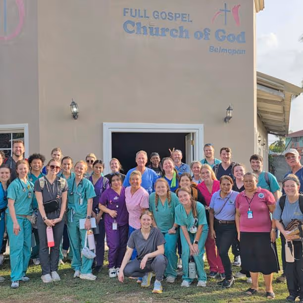 ETSU student pharmacists and faculty posed with community people in Belize outside the Full Gospel Church of God Belmopan